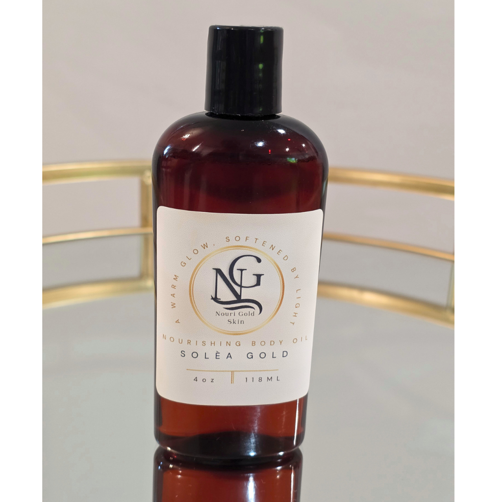 Bottle of Solea Gold body oil with a visible label on a reflective surface.